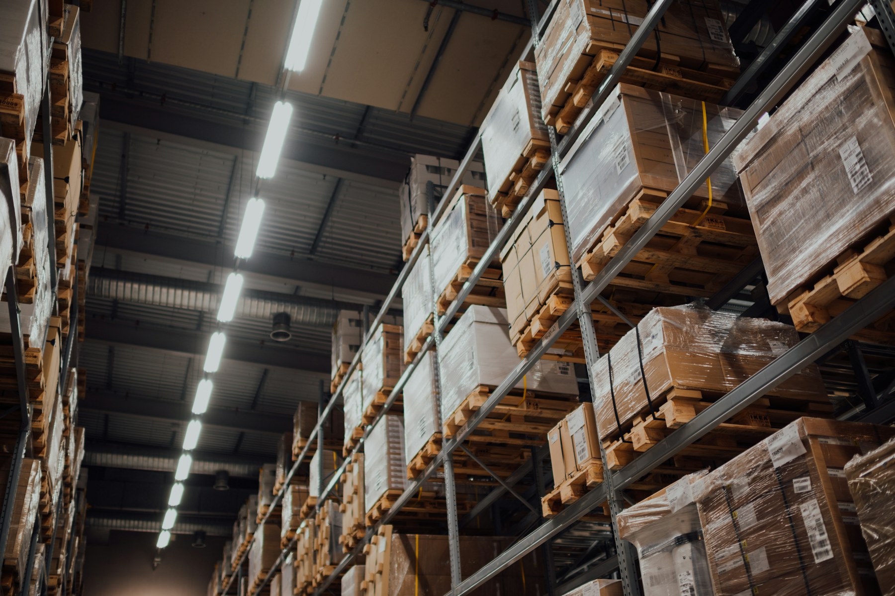 Cartons and packaged goods organized on warehouse shelving